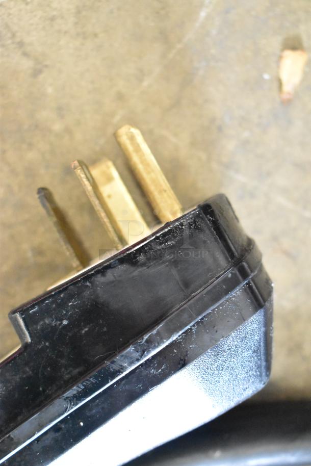 Close-up of the power plug for Fri-jado TDR 7 P commercial rotisserie oven, showcasing the prongs and black casing.