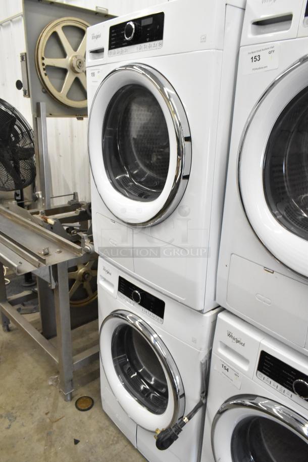 Two Whirlpool front-load dryers stacked, metal finish, buttons visible. Excellent condition, marked for auction. Model details not specified.