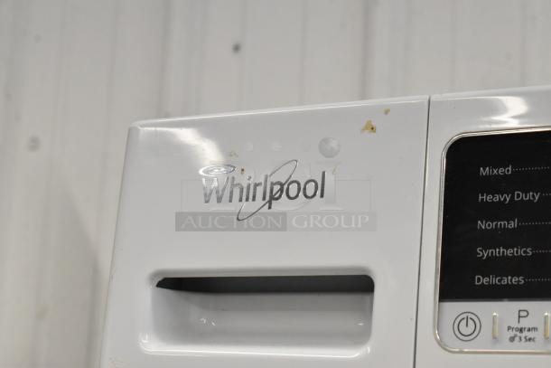 Two Whirlpool front load dryers, metal body, visible controls for mixed, heavy duty, normal settings; minor surface wear.