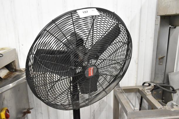 Dayton 2LY97B black metal floor fan, 120V, 1 phase, features protective mesh grill and branding label, in good condition.