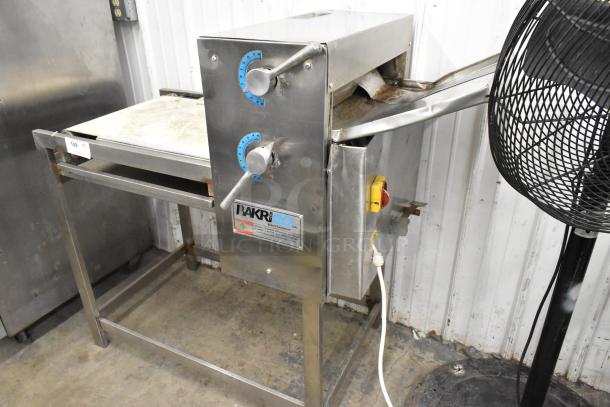 Bakri Co metal commercial floor-style dough sheeter, 250 volts, with adjustable knobs, in good condition.