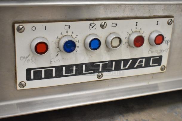 Multivac A300/22 commercial vacuum sealer control panel with various knobs and buttons. Model label visible.