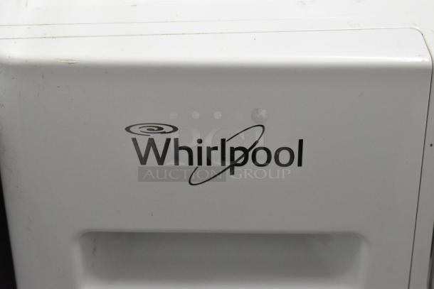 Whirlpool front load dryer, metal exterior, 120V, 1 phase. Visible Whirlpool logo. Minor wear on surface.