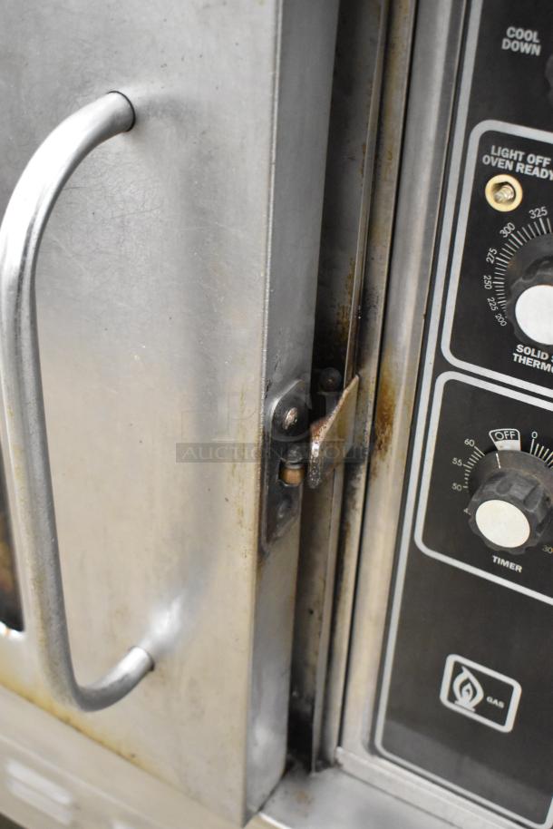 Blodgett stainless steel gas convection oven, view through door, thermostatic controls, metal racks, commercial use.