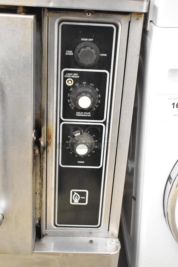 Blodgett stainless steel gas convection oven with view through door, metal racks, and thermostatic controls. Auction item.
