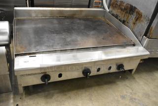 Radiance stainless steel commercial gas griddle, flat top, used condition, visible knobs, model 167 label.