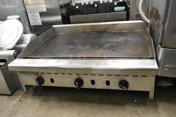 Radiance Stainless Steel Commercial Gas Flat Top Griddle, three control knobs, used condition, minor surface wear.