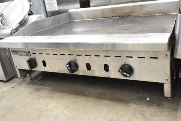 Radiance stainless steel commercial gas griddle with three control knobs, used condition, featuring a flat top cooking surface.