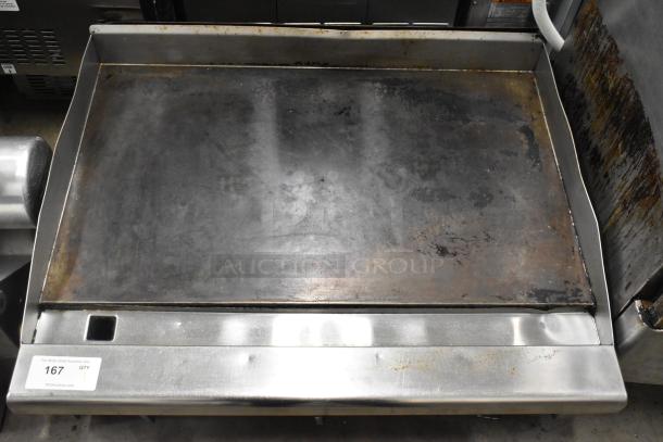 Radiance stainless steel gas flat top griddle, commercial-grade, used condition, visible wear on cooking surface, tag "167 QTY".