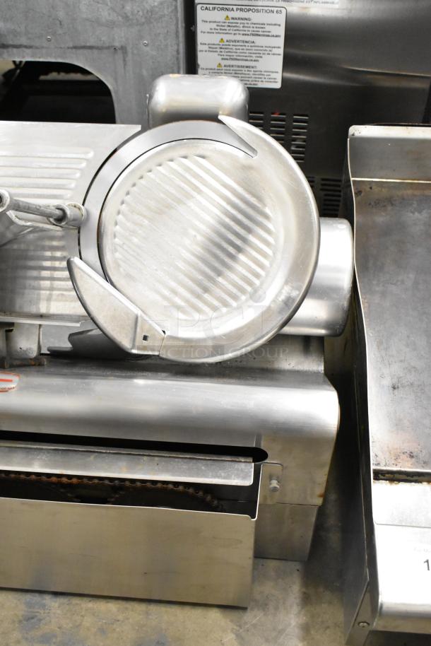 Globe 775 stainless steel commercial automatic meat slicer with blade sharpener. 115V, 1 Phase. Features sturdy construction.