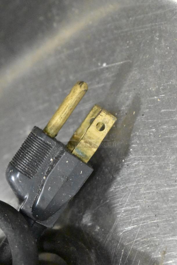 Close-up of a power plug for a Globe 775 Stainless Steel Commercial Automatic Countertop Meat Slicer.