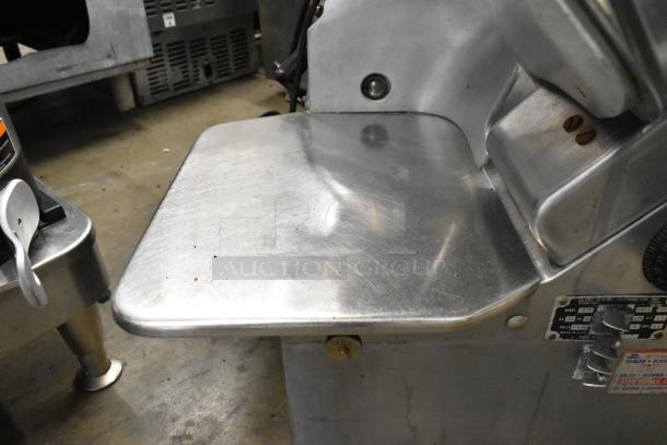 Globe 775 Stainless Steel Commercial Automatic Meat Slicer, with blade sharpener, 115V, 1 Phase, in good condition.
