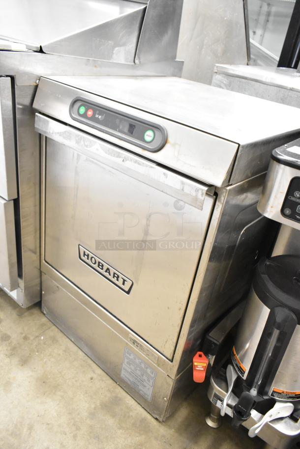 Hobart LXIH stainless steel undercounter dishwasher, commercial grade. Visible control panel, good condition. 120/208V, 1 phase.