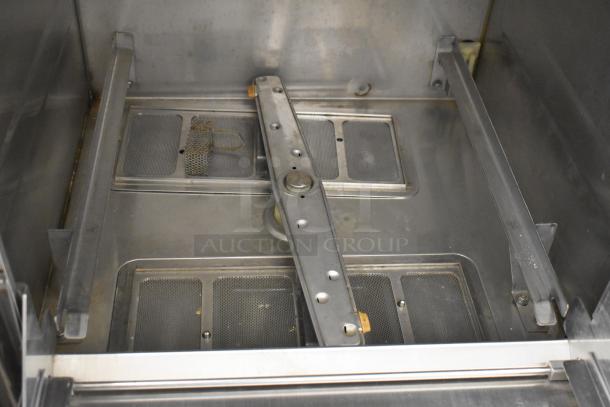 Hobart LXIH stainless steel undercounter dishwasher interior, showing spray arm and filter screens. Model for commercial use.