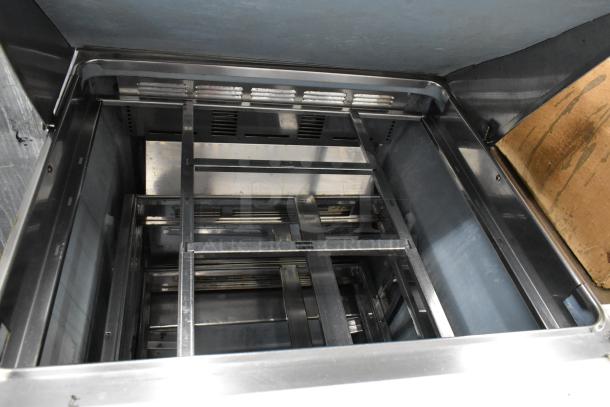 Delfield stainless steel prep table inside view, showing sturdy metal frame and structure, ideal for commercial use.