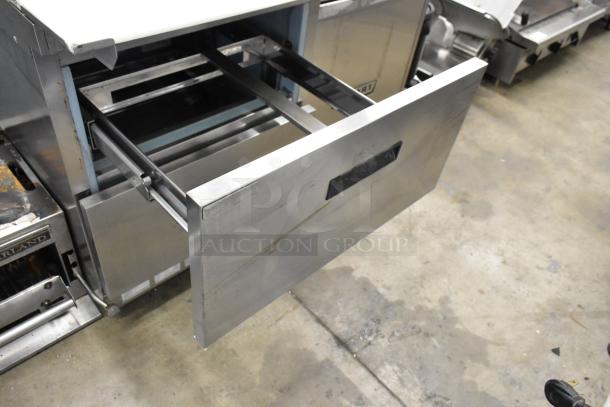 Delfield stainless steel sandwich salad prep table with two drawers, commercial casters, 115 volts, 1 phase, visible drawer.