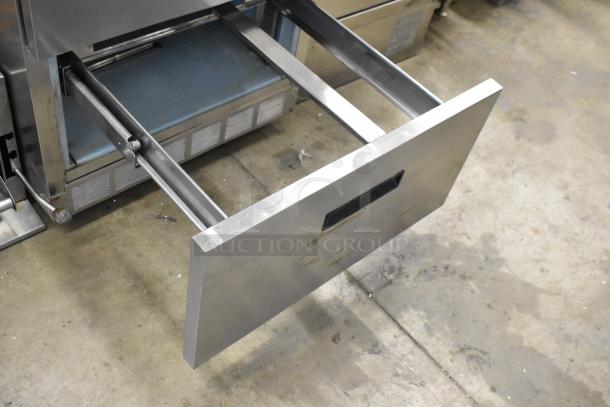 Delfield stainless steel sandwich salad prep table with two open drawers, on commercial casters. 115 volts, 1 phase.
