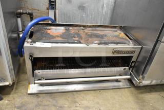 Garland stainless steel commercial gas-powered cheese melter with rust and wear. Garland logo visible, tag number 174.
