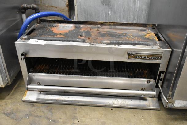 Garland Stainless Steel Commercial Gas Cheese Melter, visibly used, some rust on top. Garland logo on front.