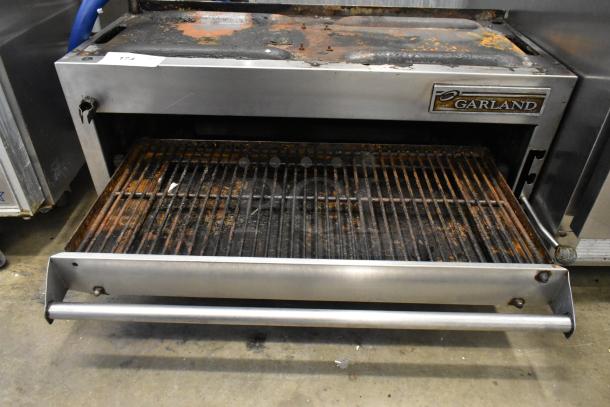Garland Stainless Steel Commercial Gas Cheese Melter, used condition, rust on grates, Garland logo visible.