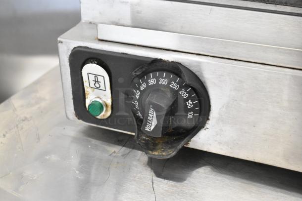 Vollrath Cayenne stainless steel panini press with adjustable temperature dial, 120 volts, showing wear and usage marks.