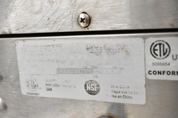 Vollrath Cayenne Panini Press label, scratched stainless steel, 120 volts, 1 phase, NSF and ETL certifications visible.