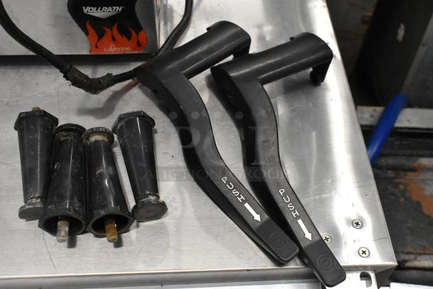 Bunn stainless steel slushie machine parts, including push levers and feet, shown on countertop. Missing lids.