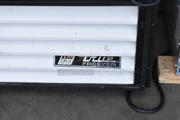 True GDM-23F Metal Commercial Freezer Merchandiser with poly coated racks, 115V, 1 Phase. Brand label visible.