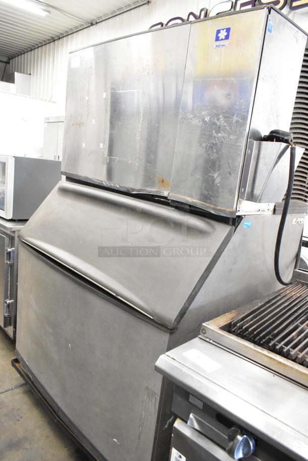 Manitowoc SY1405W stainless steel ice machine head on B970 bin. 208-230V, 1 phase. Used condition, visible wear marks.