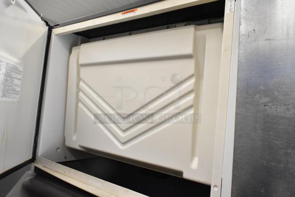 Manitowoc SY1405W stainless steel commercial ice machine head on B970 bin. 208-230V, 1 phase, open door view.