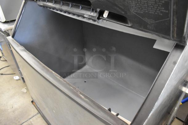 Manitowoc SY1405W stainless steel ice machine head on B970 bin, 208-230V, 1 phase. Used condition, open bin showing interior.
