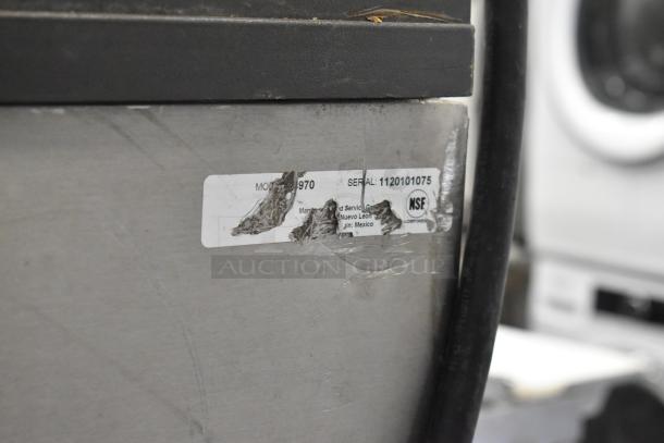 Manitowoc SY1405W ice machine head on B970 bin. Stainless steel, 208-230V, 1 phase. Visible wear on label.