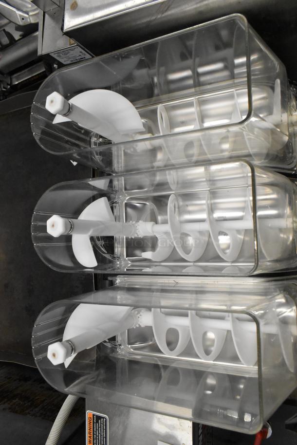 Elmeco FC3 stainless steel 3-hopper slushie machine, showing clear hoppers and internal augers, 115 volts, 1 phase, commercial use.