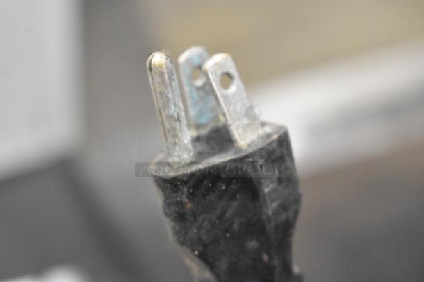 Close-up of a metal prong on a power plug for a 2017 Bunn HW2 Hot Water Dispenser. 120 Volts, 1 Phase.