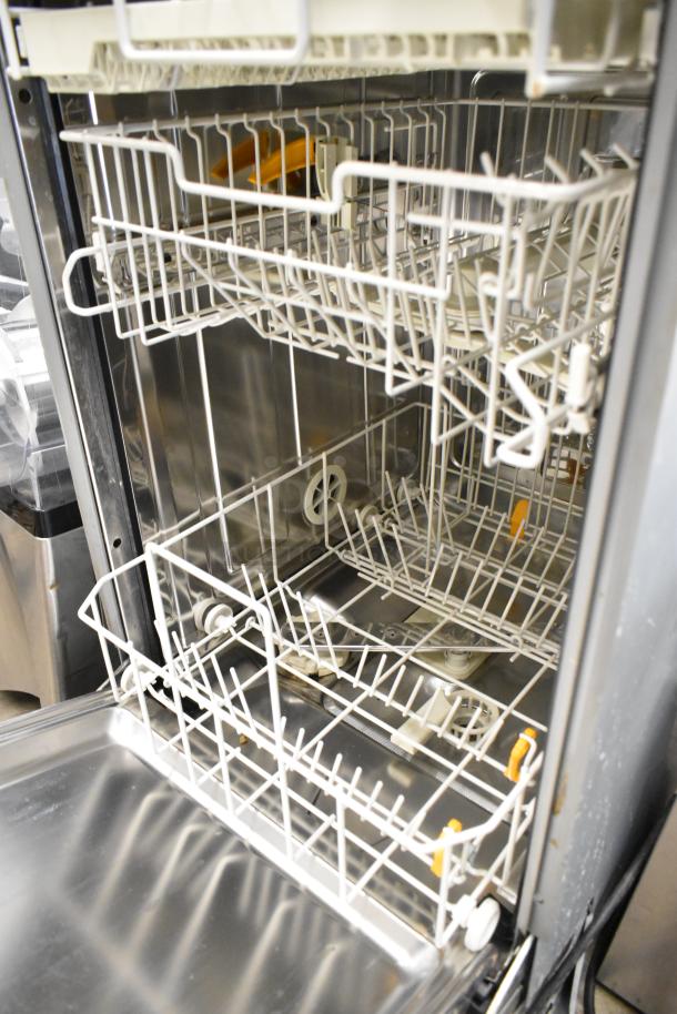 Miele G4700SCi stainless steel undercounter dishwasher, open view showing interior racks. Model in excellent condition.