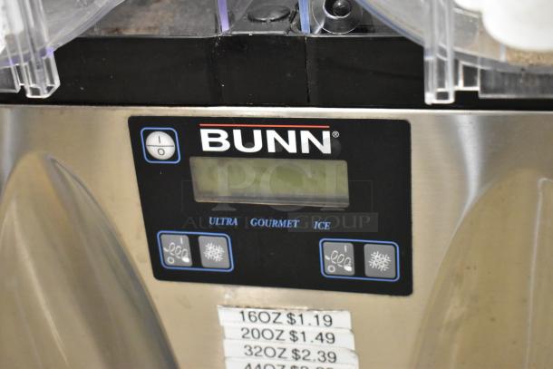 Bunn stainless steel 2 hopper slushie machine, no lids, visible control panel. Note hopper damage, 115V, 1 phase.