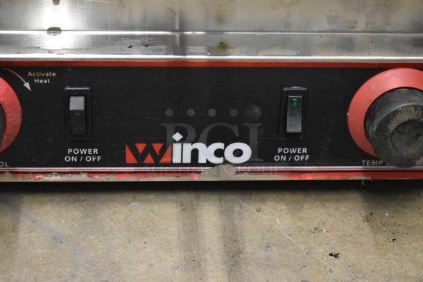 Winco EPG-2 stainless steel commercial double panini press, 120V, featuring power switches and adjustable temperature knobs.