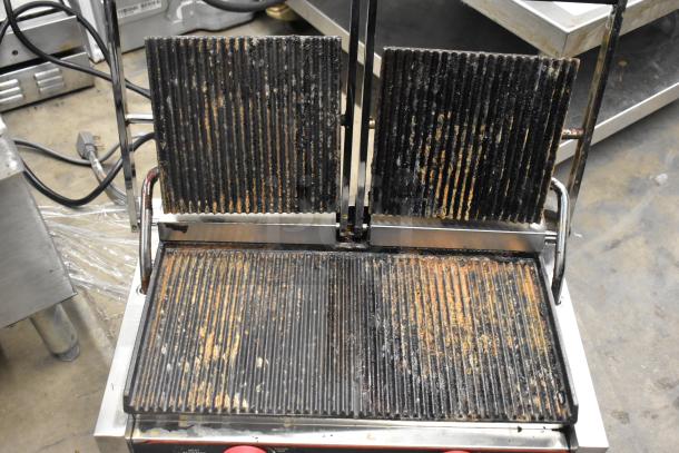 Winco EPG-2 stainless steel commercial double panini press, 120 volts, visible signs of use on grill plates.