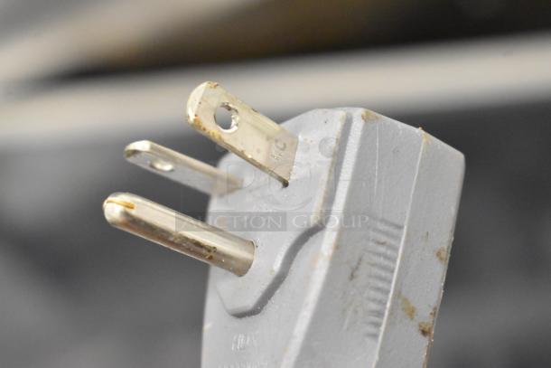 Close-up of a power plug for a CookTek MSP7000-200 induction range. The plug shows signs of wear and use.