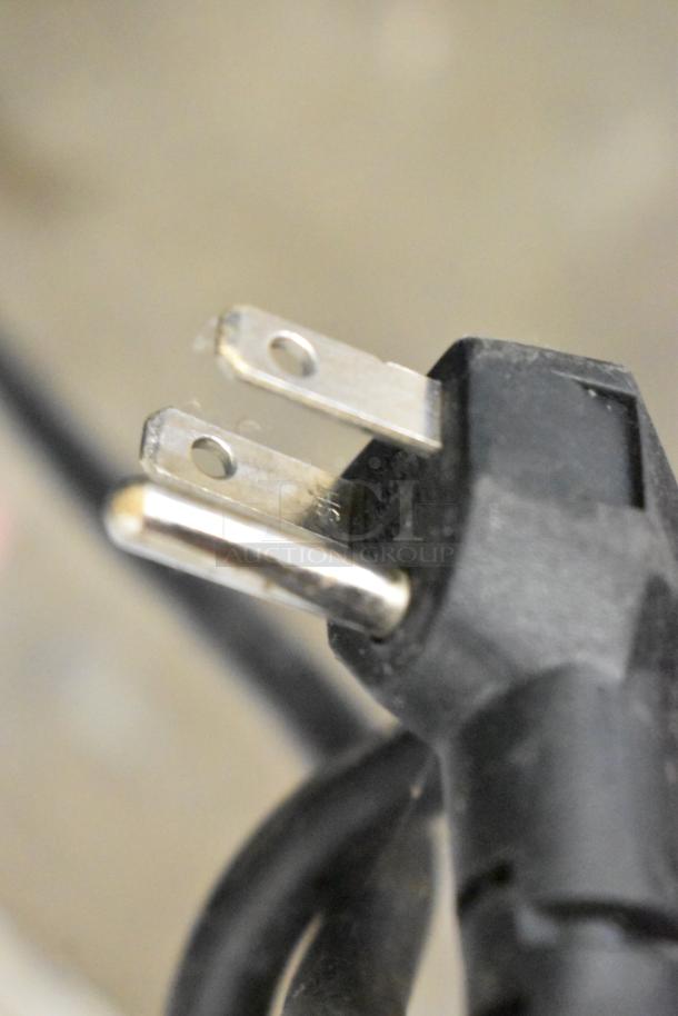 Close-up of the power plug for the Blue Air BLUI-150A ice machine, showing a standard 115V, 3-prong plug.
