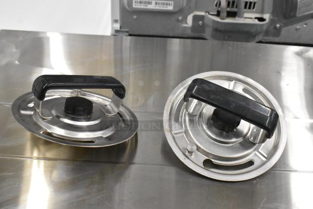 Fetco CBS-62H coffee machine with stainless steel brew basket lids, commercial countertop model, dual server design.