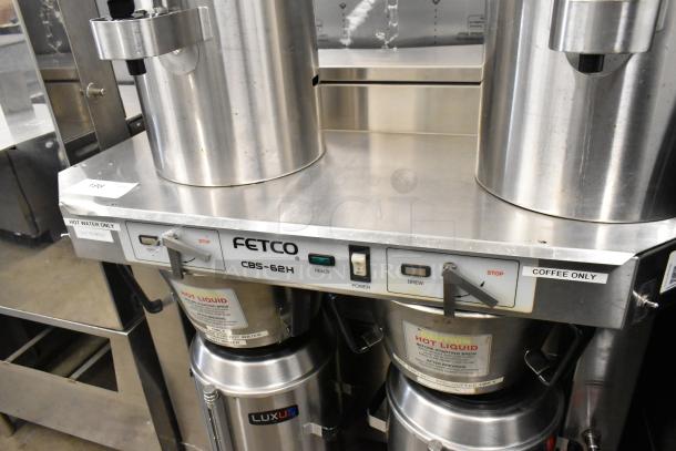 Fetco CBS-62H stainless steel double coffee machine with hot water dispenser, two brew baskets, four servers, 120/208-240V, 1 phase.