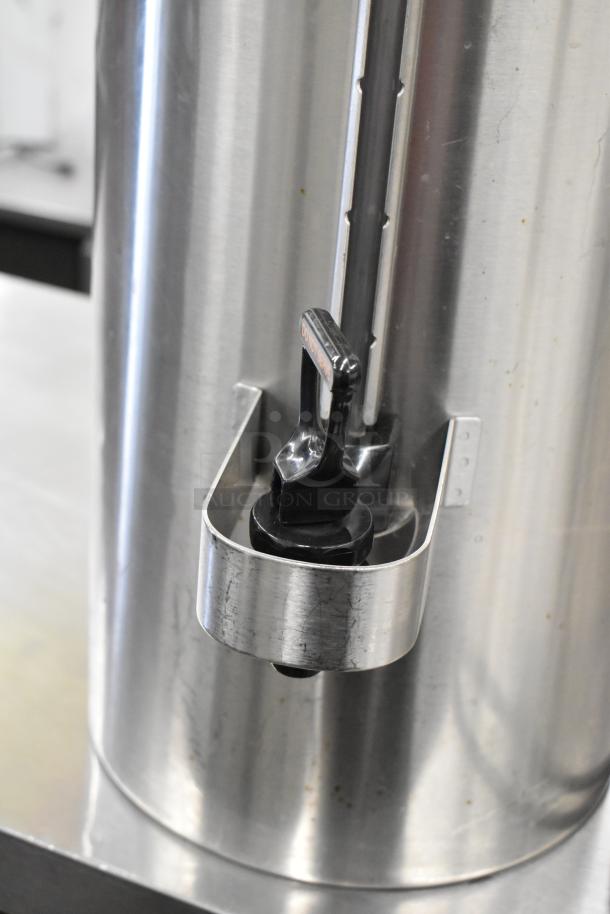 Fetco CBS-62H stainless steel coffee machine with hot water dispenser, close-up of spout. Includes 2 brew baskets, 4 servers.