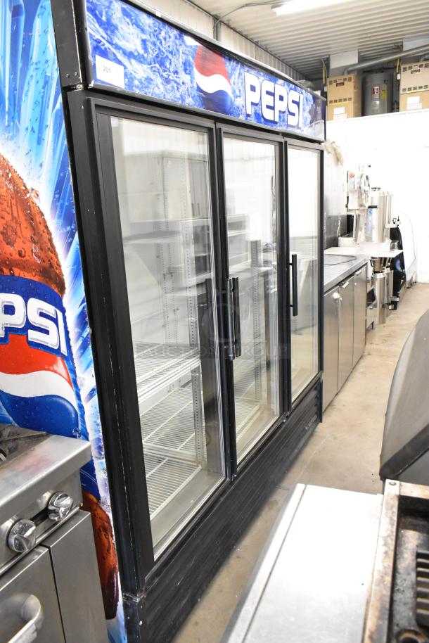 True GDM-72 metal commercial 3-door reach-in cooler merchandiser, features Pepsi branding, poly-coated racks, 115 volts, 1 phase.