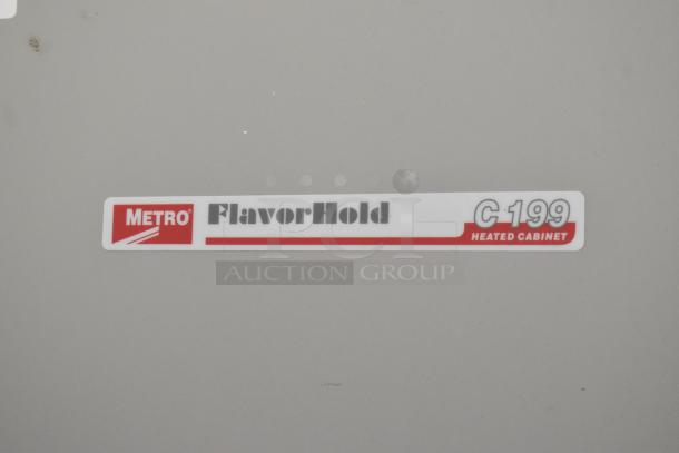 Metro FlavorHold C199 Heated Holding Cabinet label on a commercial unit, indicating brand and model.