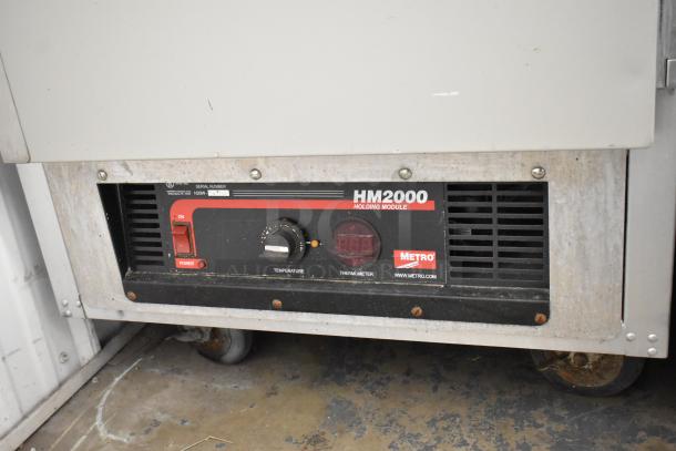 Metro FlavorHold C199 heated holding cabinet, metal construction, commercial casters, HM2000 holding module, visible wear.
