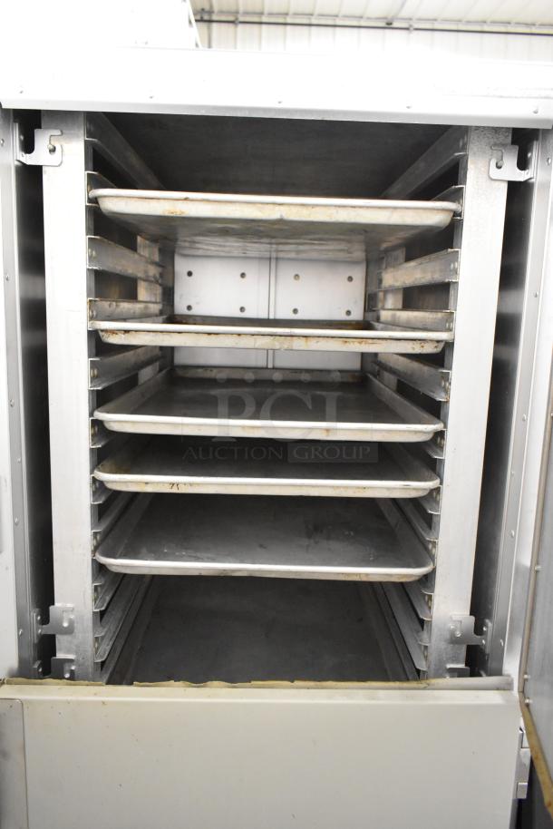 Metro FlavorHold C199 metal commercial heated holding cabinet with racks, on commercial casters, in used condition.