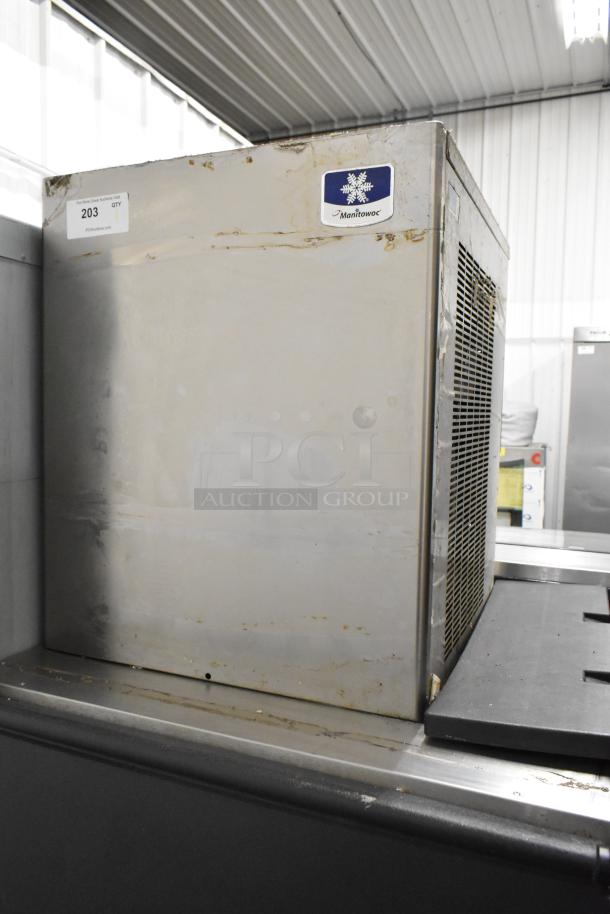Manitowoc RFS0300A stainless steel ice head on bin, 115 volts, 1 phase, visible wear, placed in commercial setting.