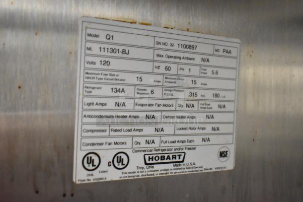 Label on Hobart Q1 single door cooler, detailing model Q1, voltage 120, refrigerant type 134A, and design pressure 315 P.S.I.G.