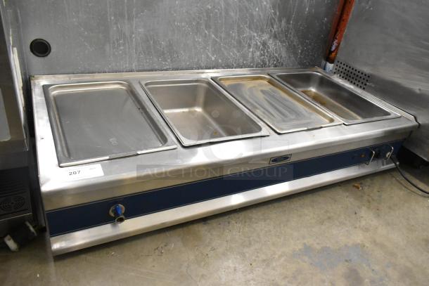 Stainless steel commercial countertop electric 4-well steam table, untested, previously hardwired, shows signs of use.
